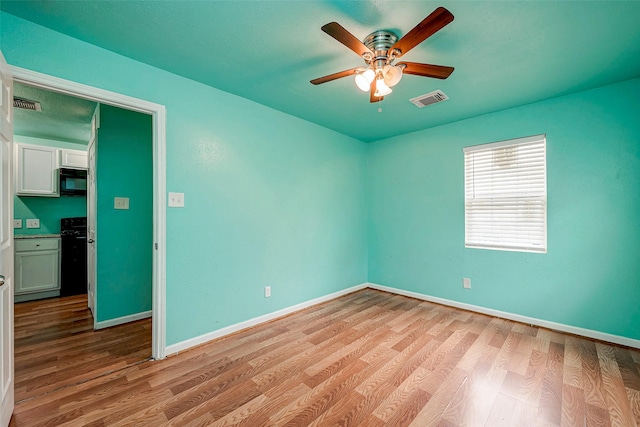3938 King St, Houston, TX 77026 - empty room with wood finished floors and a ceiling fan