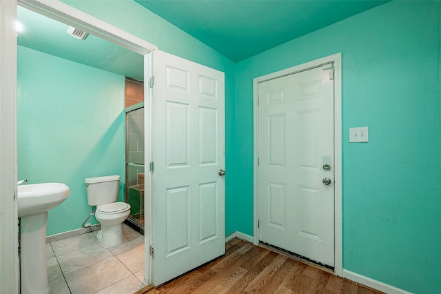 3938 King St, Houston, TX 77026 - full bathroom with a shower stall and wood finished floors