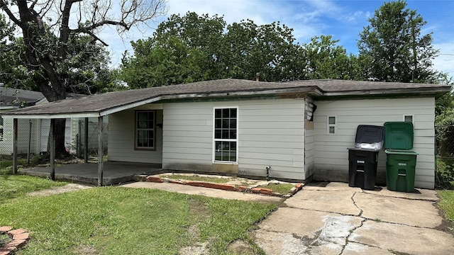 7338 Hurtgen Forest Rd, Houston, TX 77033 - rear view of house with a patio, a yard, and a shingled roof