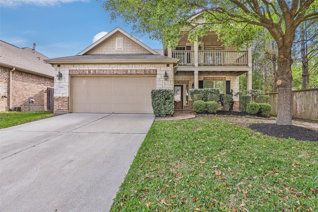 24143 Auburn Woods Ct, Porter, TX 77365 - view of front facade with a balcony, driveway, a garage, and brick siding