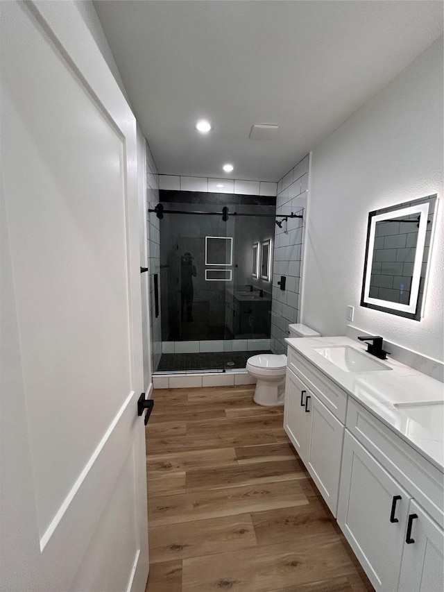 6206 Lyndhurst Dr, Houston, TX 77087 - bathroom with a stall shower, vanity, wood finished floors, and recessed lighting