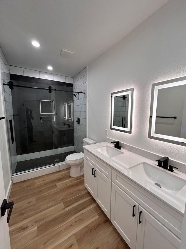 6206 Lyndhurst Dr, Houston, TX 77087 - full bath featuring double vanity, a shower stall, wood finished floors, and recessed lighting