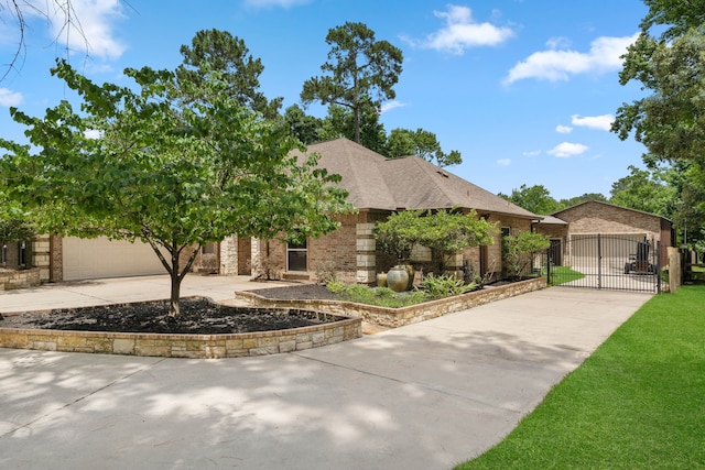 806 Garrett Dr, Magnolia, TX 77354 - view of front of property featuring a gate, concrete driveway, brick siding, and a shingled roof