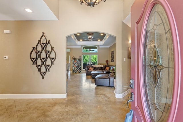 806 Garrett Dr, Magnolia, TX 77354 - foyer with ceiling fan, ornamental molding, arched walkways, a tray ceiling, and finished concrete flooring