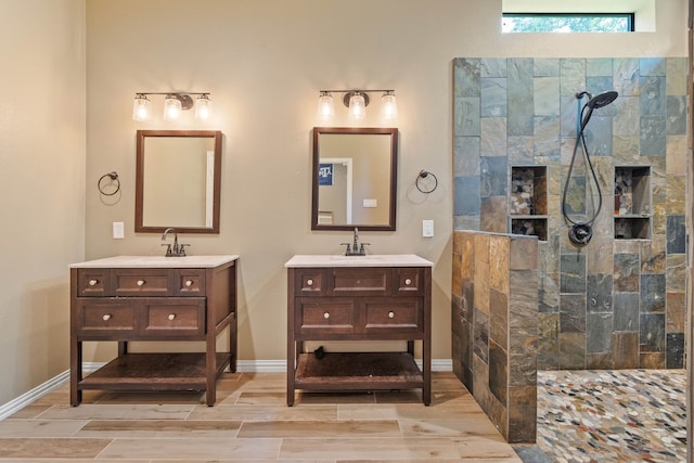806 Garrett Dr, Magnolia, TX 77354 - full bathroom featuring walk in shower, two vanities, and wood finish floors