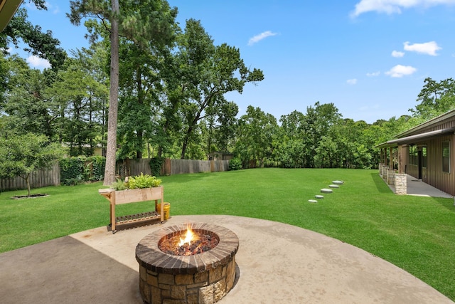 806 Garrett Dr, Magnolia, TX 77354 - fenced backyard with a patio area and a fire pit