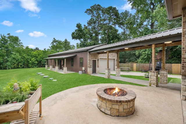 806 Garrett Dr, Magnolia, TX 77354 - view of patio with a fire pit and an attached garage