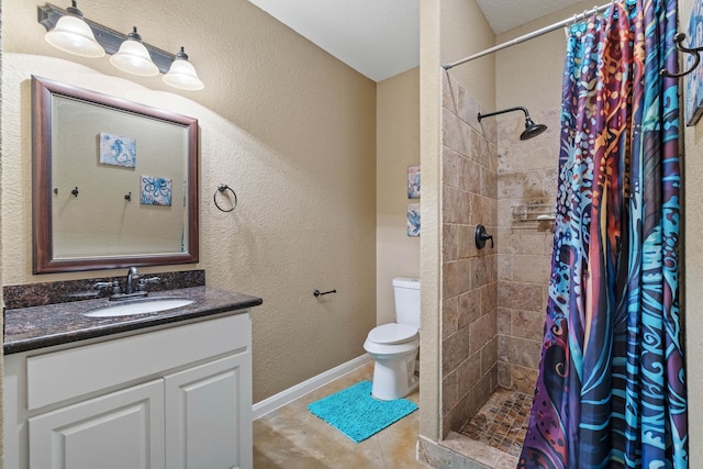 806 Garrett Dr, Magnolia, TX 77354 - bathroom featuring vanity, a tile shower, a textured wall, and tile patterned floors