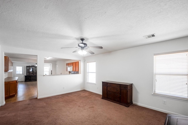 2630 Skyview Crest Ct, Houston, TX 77047 - unfurnished living room with ceiling fan, carpet flooring, and a textured ceiling