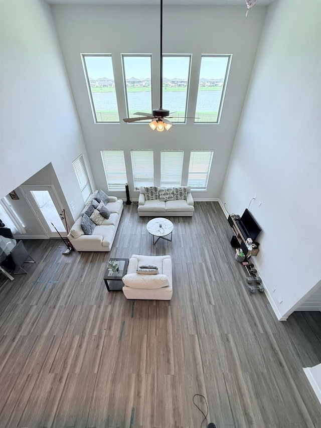 18542 Twilight Arbor Trl, Richmond, TX 77407 - living room with wood finished floors, a towering ceiling, ceiling fan, and a water view