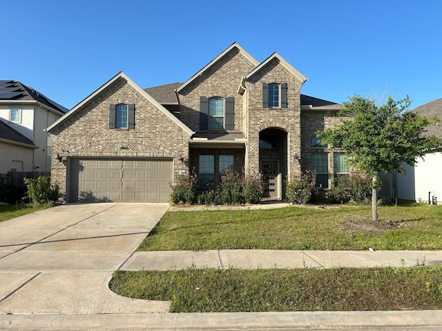 18542 Twilight Arbor Trl, Richmond, TX 77407 - french country inspired facade featuring brick siding, concrete driveway, a front lawn, and an attached garage