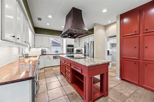 4611 Diamond Springs Dr, Missouri City, TX 77459 - kitchen featuring island range hood, appliances with stainless steel finishes, stone tile flooring, a kitchen island, and tasteful backsplash