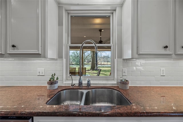 4611 Diamond Springs Dr, Missouri City, TX 77459 - kitchen featuring white cabinetry, dark stone counters, and tasteful backsplash