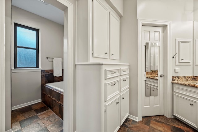 4611 Diamond Springs Dr, Missouri City, TX 77459 - full bathroom featuring stone tile flooring, vanity, and a bath