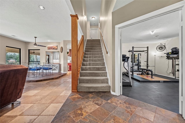 4611 Diamond Springs Dr, Missouri City, TX 77459 - stairs featuring a textured ceiling, stone tile floors, ceiling fan, and recessed lighting