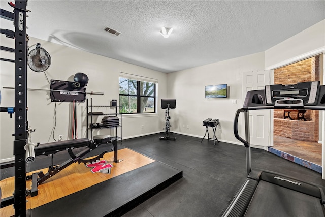 4611 Diamond Springs Dr, Missouri City, TX 77459 - workout area featuring baseboards and a textured ceiling
