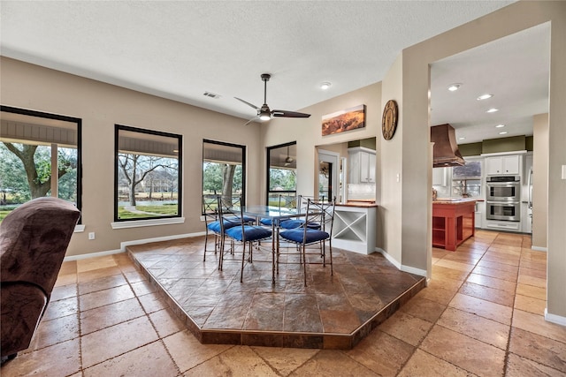 4611 Diamond Springs Dr, Missouri City, TX 77459 - dining area with stone tile floors, healthy amount of natural light, a ceiling fan, recessed lighting, and a textured ceiling