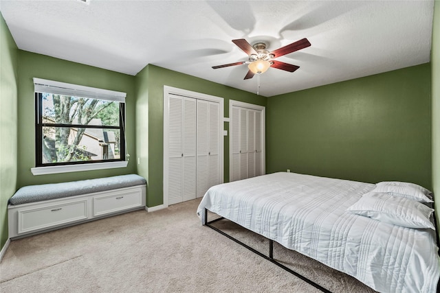 4611 Diamond Springs Dr, Missouri City, TX 77459 - bedroom featuring light colored carpet, two closets, and ceiling fan