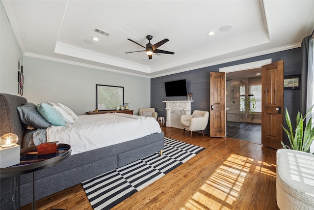 1014 E 25th St, Houston, TX 77009 - bedroom with a tray ceiling, wood finished floors, ornamental molding, ceiling fan, and recessed lighting