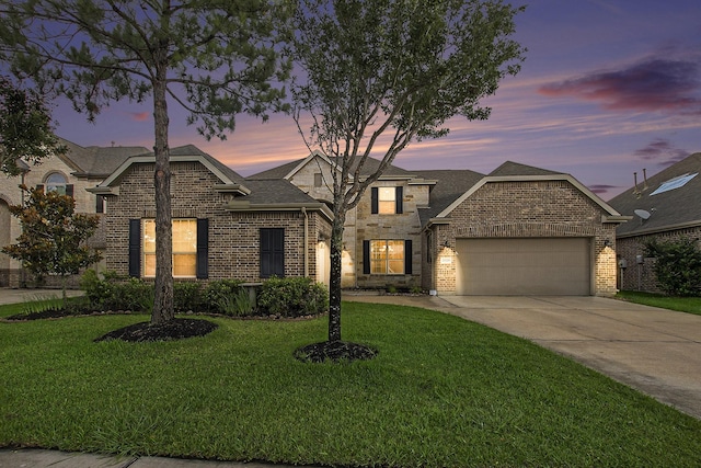 20226 Overland Hills Ln, Cypress, TX 77433 - french provincial home featuring an attached garage, a front lawn, driveway, and brick siding