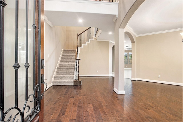 20226 Overland Hills Ln, Cypress, TX 77433 - entryway featuring arched walkways, ornamental molding, dark wood-type flooring, and stairs