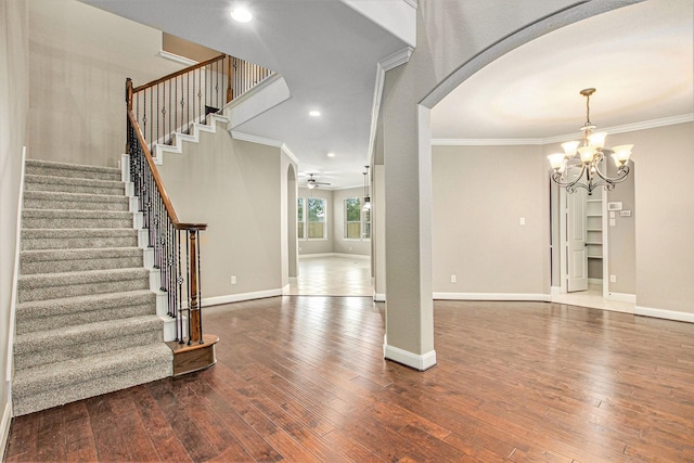 20226 Overland Hills Ln, Cypress, TX 77433 - entryway featuring arched walkways, crown molding, wood-type flooring, stairs, and a chandelier