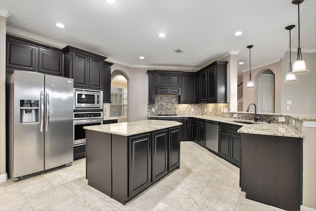 20226 Overland Hills Ln, Cypress, TX 77433 - kitchen featuring stainless steel appliances, arched walkways, ornamental molding, a peninsula, and a center island