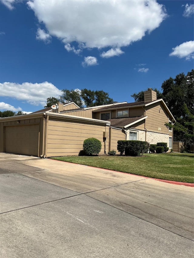 2372 Woodland Park Dr Unit 121, Houston, TX 77077 - view of property exterior with a chimney, a lawn, and driveway