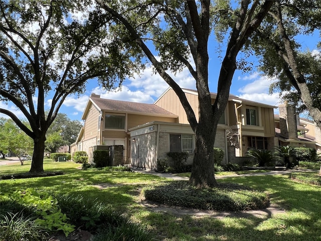 2372 Woodland Park Dr Unit 121, Houston, TX 77077 - view of front of house featuring stone siding and a front yard