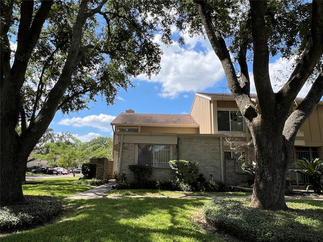 2372 Woodland Park Dr Unit 121, Houston, TX 77077 - back of house with a yard, brick siding, and a chimney