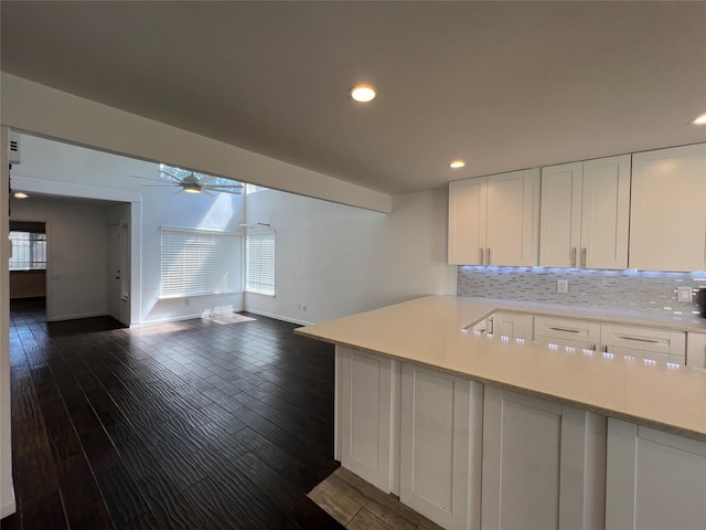 2372 Woodland Park Dr Unit 121, Houston, TX 77077 - kitchen featuring ceiling fan, light countertops, white cabinets, open floor plan, and tasteful backsplash