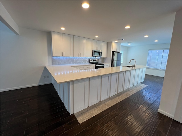 2372 Woodland Park Dr Unit 121, Houston, TX 77077 - kitchen featuring appliances with stainless steel finishes, light countertops, dark wood finished floors, white cabinets, and recessed lighting