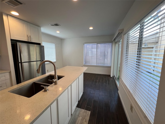 2372 Woodland Park Dr Unit 121, Houston, TX 77077 - kitchen featuring freestanding refrigerator, dark wood-type flooring, white cabinets, light stone countertops, and recessed lighting
