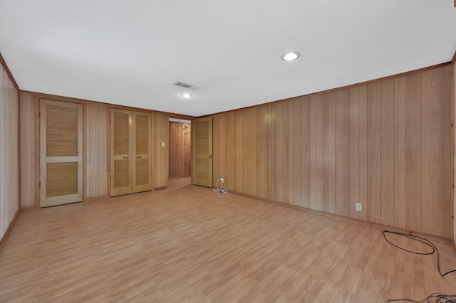 17230 Pioneer Trl, Conroe, TX 77302 - unfurnished bedroom featuring light wood-style flooring and wood walls
