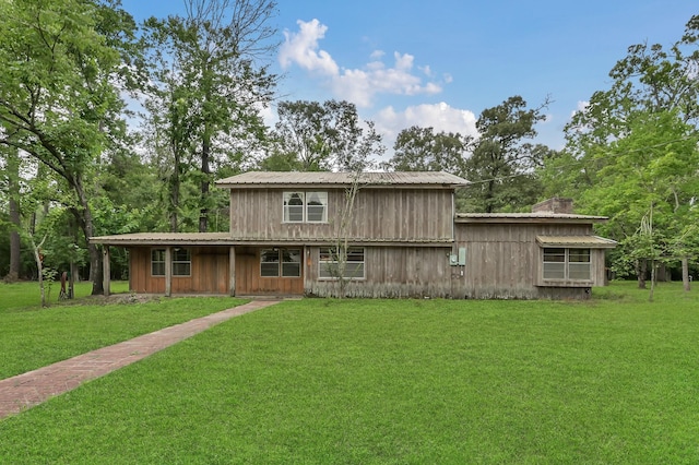 17230 Pioneer Trl, Conroe, TX 77302 - view of front facade with a front lawn and a metal roof