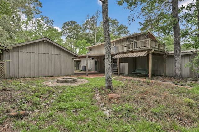 17230 Pioneer Trl, Conroe, TX 77302 - rear view of property with an outdoor fire pit and a deck