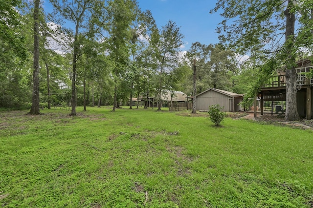 17230 Pioneer Trl, Conroe, TX 77302 - view of grassy yard featuring a wooden deck