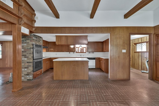 17230 Pioneer Trl, Conroe, TX 77302 - kitchen featuring double oven, white dishwasher, beamed ceiling, light countertops, and wooden walls