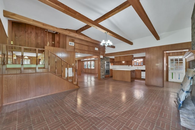 17230 Pioneer Trl, Conroe, TX 77302 - unfurnished living room with wood walls, brick patterned floors, a chandelier, and stairs