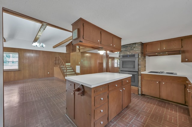17230 Pioneer Trl, Conroe, TX 77302 - kitchen featuring appliances with stainless steel finishes, brick patterned flooring, wood walls, and brown cabinetry