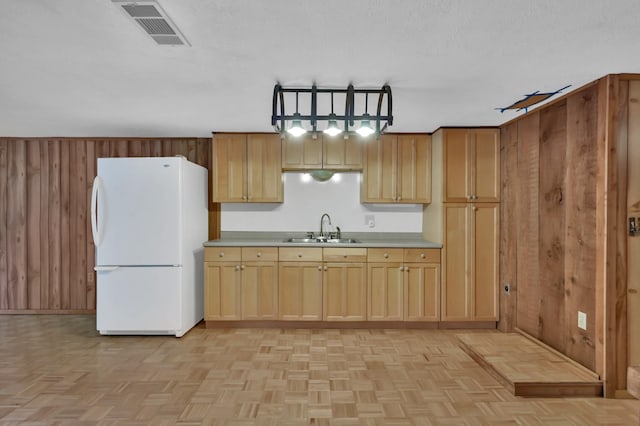17230 Pioneer Trl, Conroe, TX 77302 - kitchen featuring freestanding refrigerator, wooden walls, and light countertops