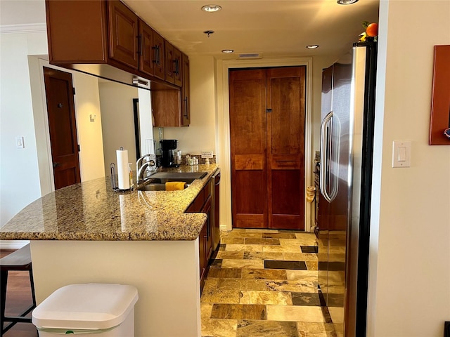 3525 Sage Rd Unit 1502, Houston, TX 77056 - kitchen featuring appliances with stainless steel finishes, a peninsula, recessed lighting, stone countertops, and a kitchen breakfast bar