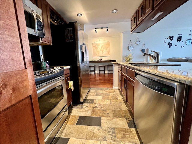 3525 Sage Rd Unit 1502, Houston, TX 77056 - kitchen featuring appliances with stainless steel finishes, light stone finish floors, light stone countertops, and recessed lighting
