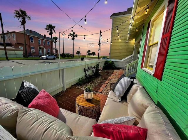 2413 34th St, Galveston, TX 77550 - patio terrace at dusk with outdoor lounge area, a patio, and a fenced backyard