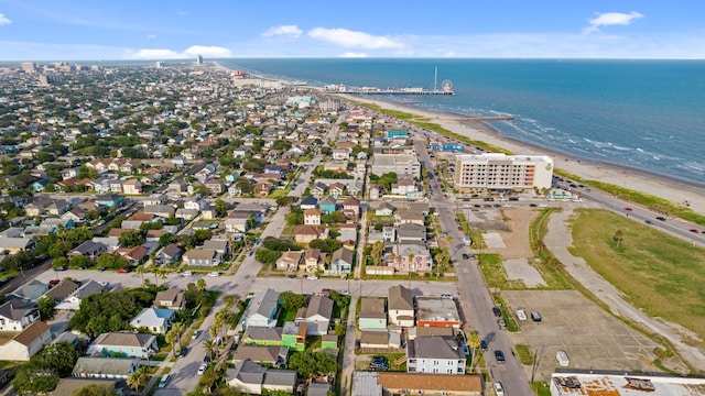 2413 34th St, Galveston, TX 77550 - aerial view of property and surrounding area featuring waterfront with a beach and nearby suburban area
