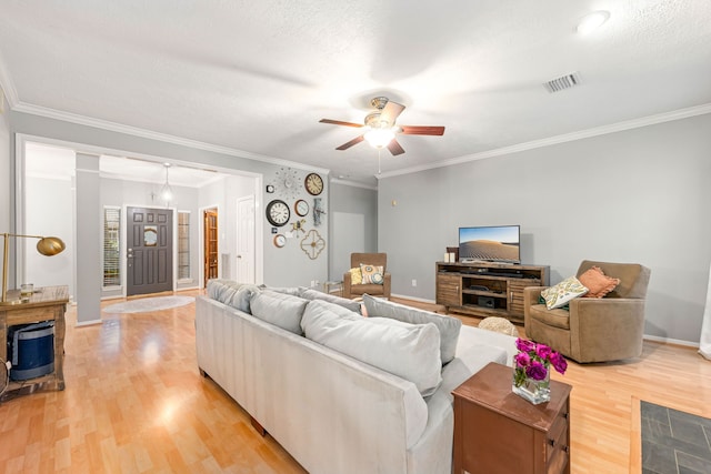 6 Heathstone Pl, The Woodlands, TX 77381 - living room with light wood finished floors, ceiling fan, and ornamental molding