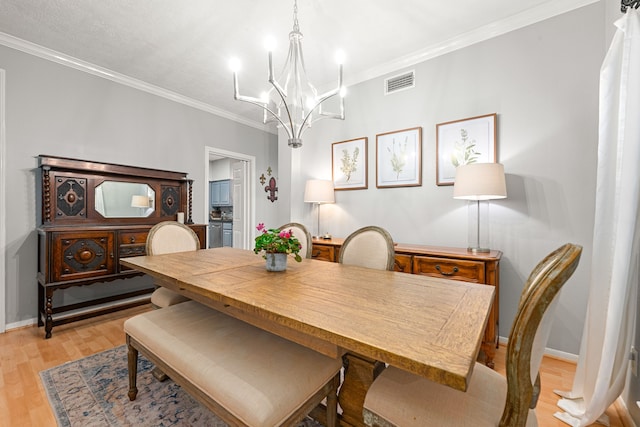 6 Heathstone Pl, The Woodlands, TX 77381 - dining room featuring a chandelier, ornamental molding, and light wood-type flooring