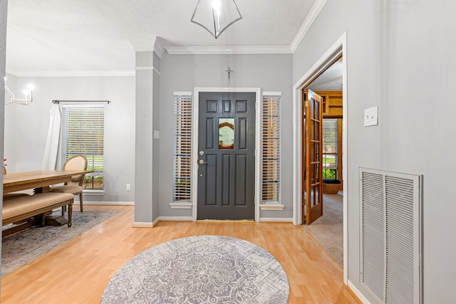 6 Heathstone Pl, The Woodlands, TX 77381 - entryway featuring light wood finished floors and crown molding