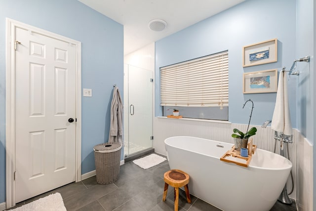 6 Heathstone Pl, The Woodlands, TX 77381 - bathroom with a soaking tub, a wainscoted wall, a stall shower, and tile patterned flooring