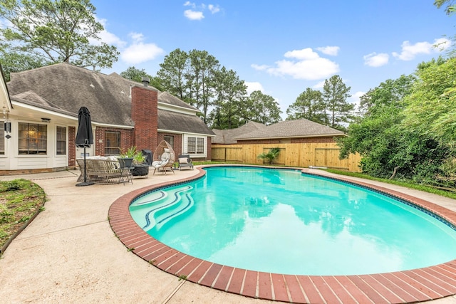 6 Heathstone Pl, The Woodlands, TX 77381 - view of swimming pool with a patio, a fenced backyard, and an outdoor living space